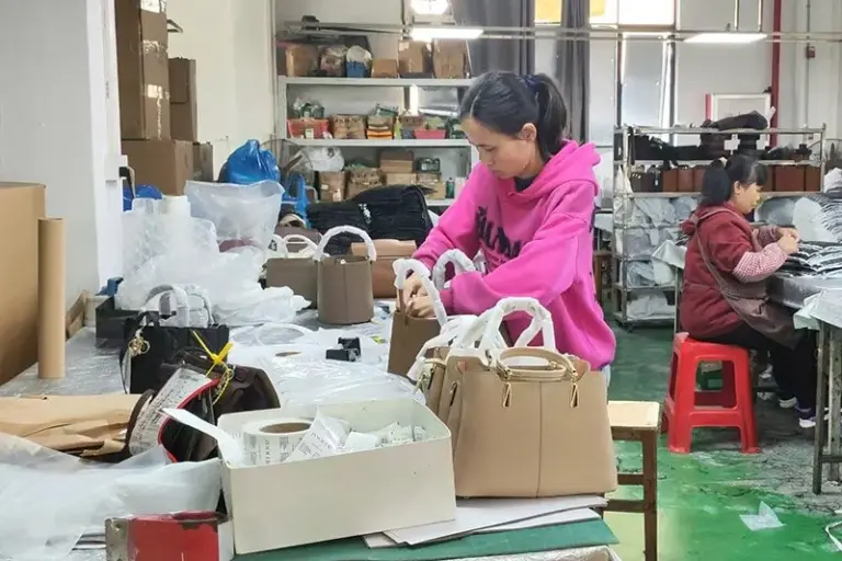 Chinese bag factory worker checking finished bags before packing