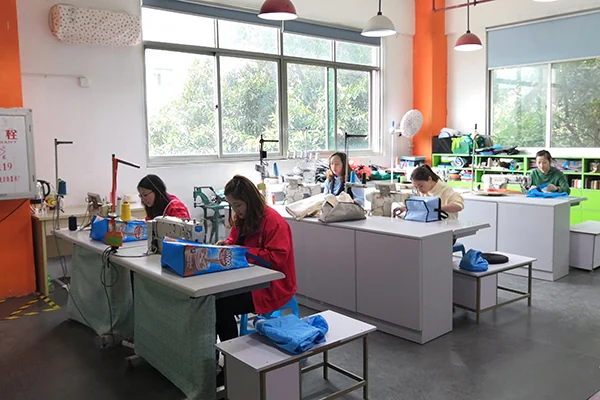 Chinese bag factory team reviewing bag samples in a clean workshop office
